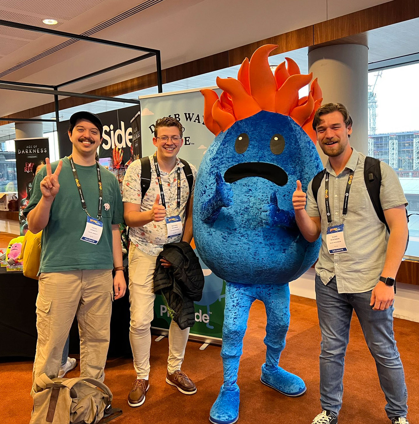 a picture with Nathan and two of his friends Oscar and Blake with the dumb ways to die mascot who is blue and has flaming hair. Taken at GCAP 2023-image
